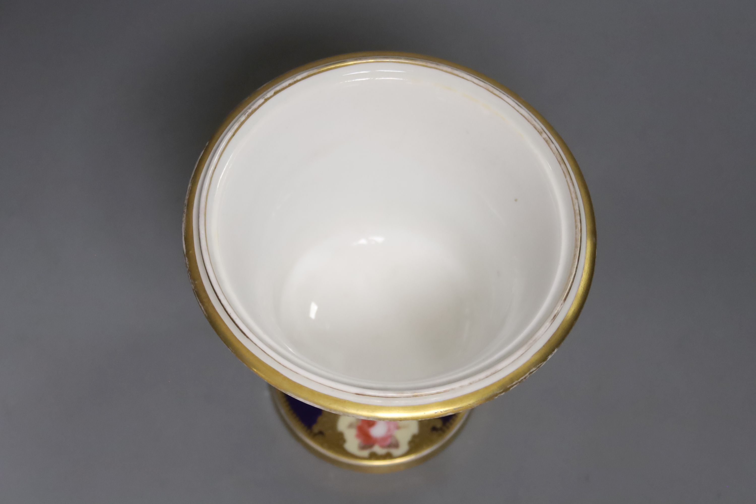 A Chamberlains Worcester two handled vase, painted with six single roses on a blue ground, height 14.5cm
